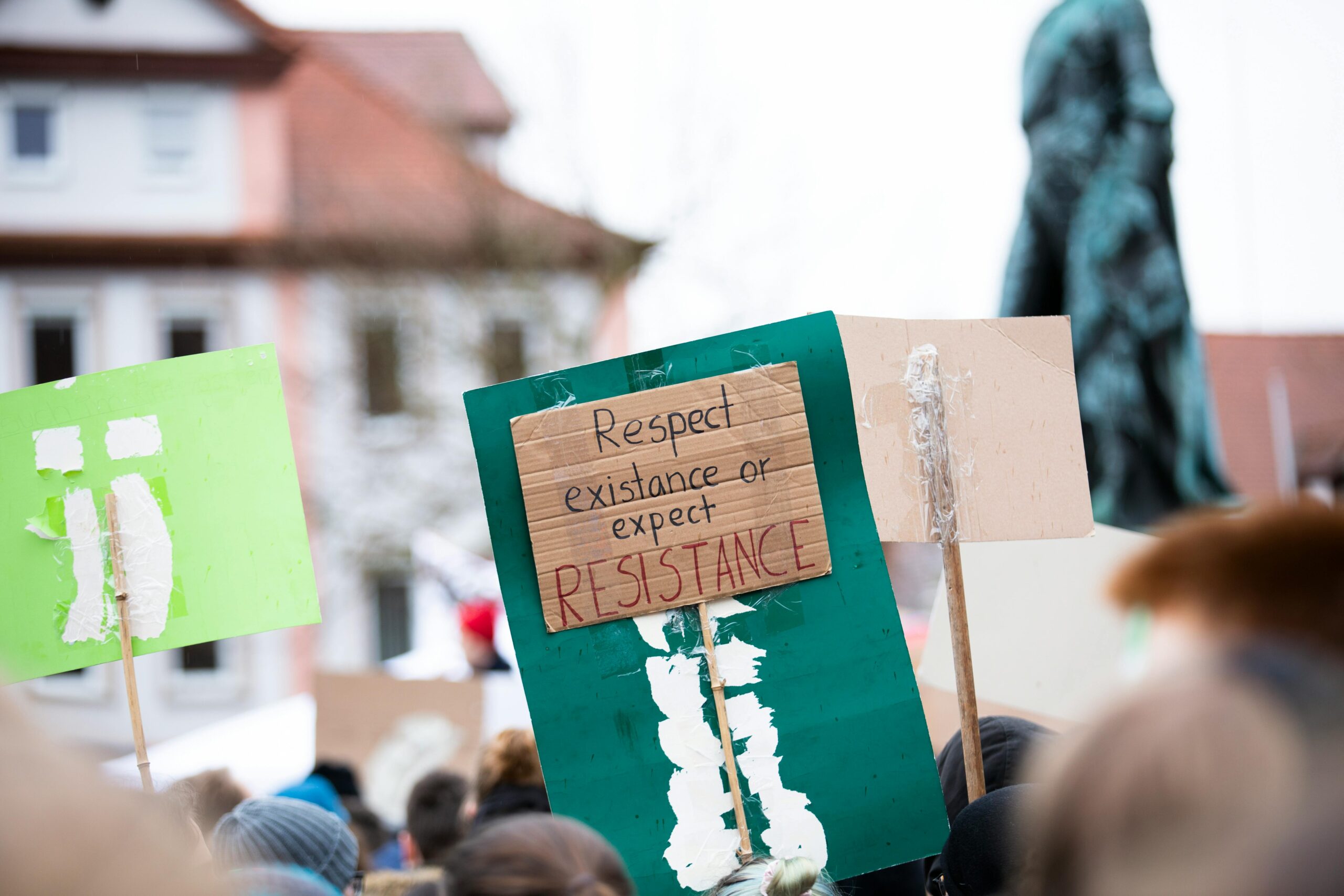 Protestors march with handmade signs in Erlangen, Germany, advocating environmental change.